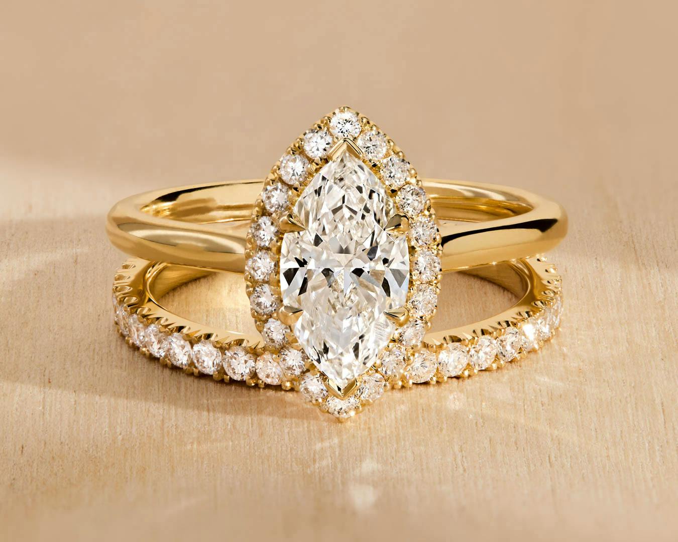 Halo engagement ring with marquise diamond in yellow gold.