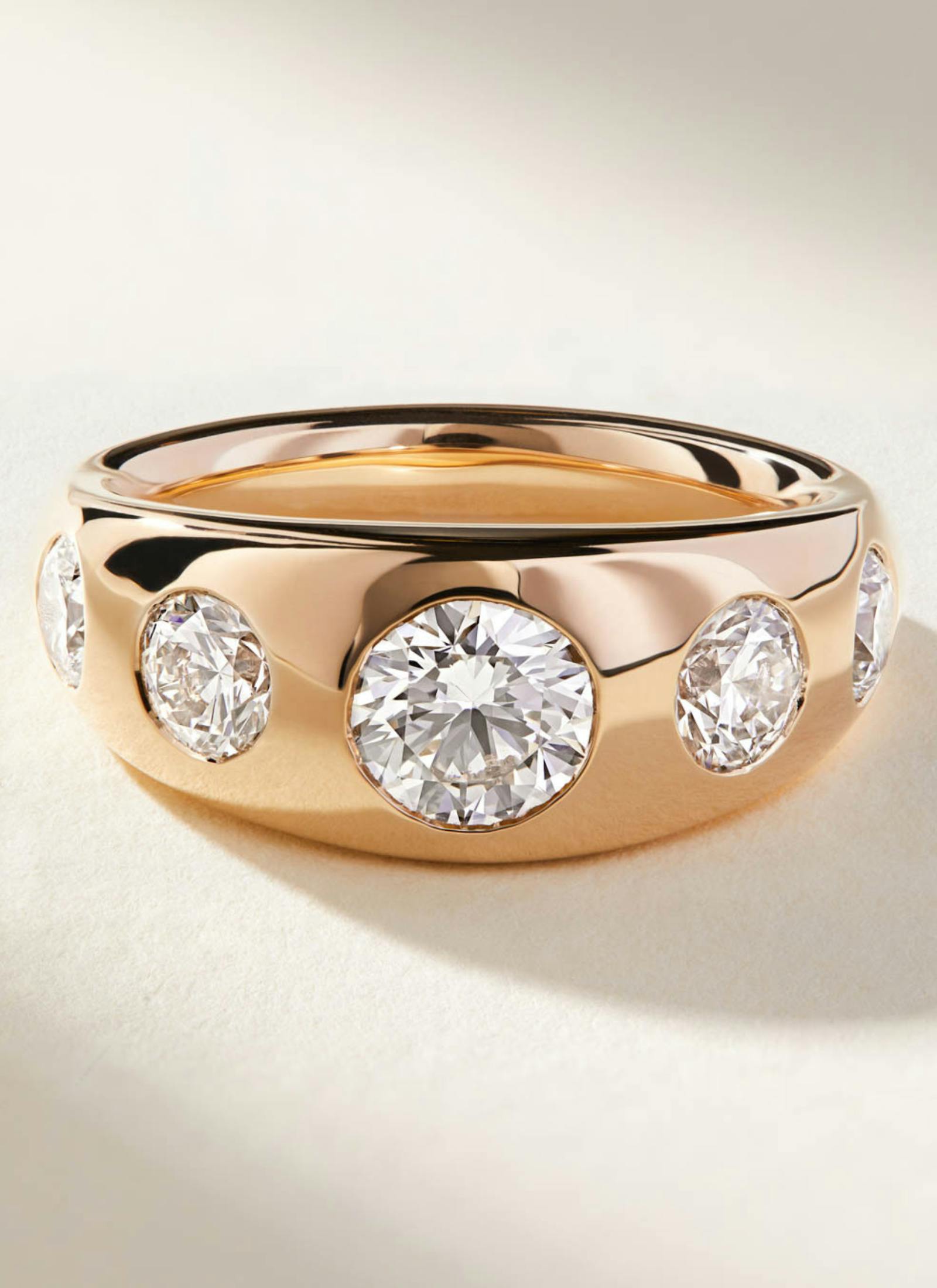 Bespoke chunky rose gold engagement ring featuring flush-set round diamonds in a bold, contemporary cigar band design, made for modern minimalists.