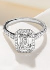 Scallop set platinum halo engagement ring with an emerald shape centre diamond