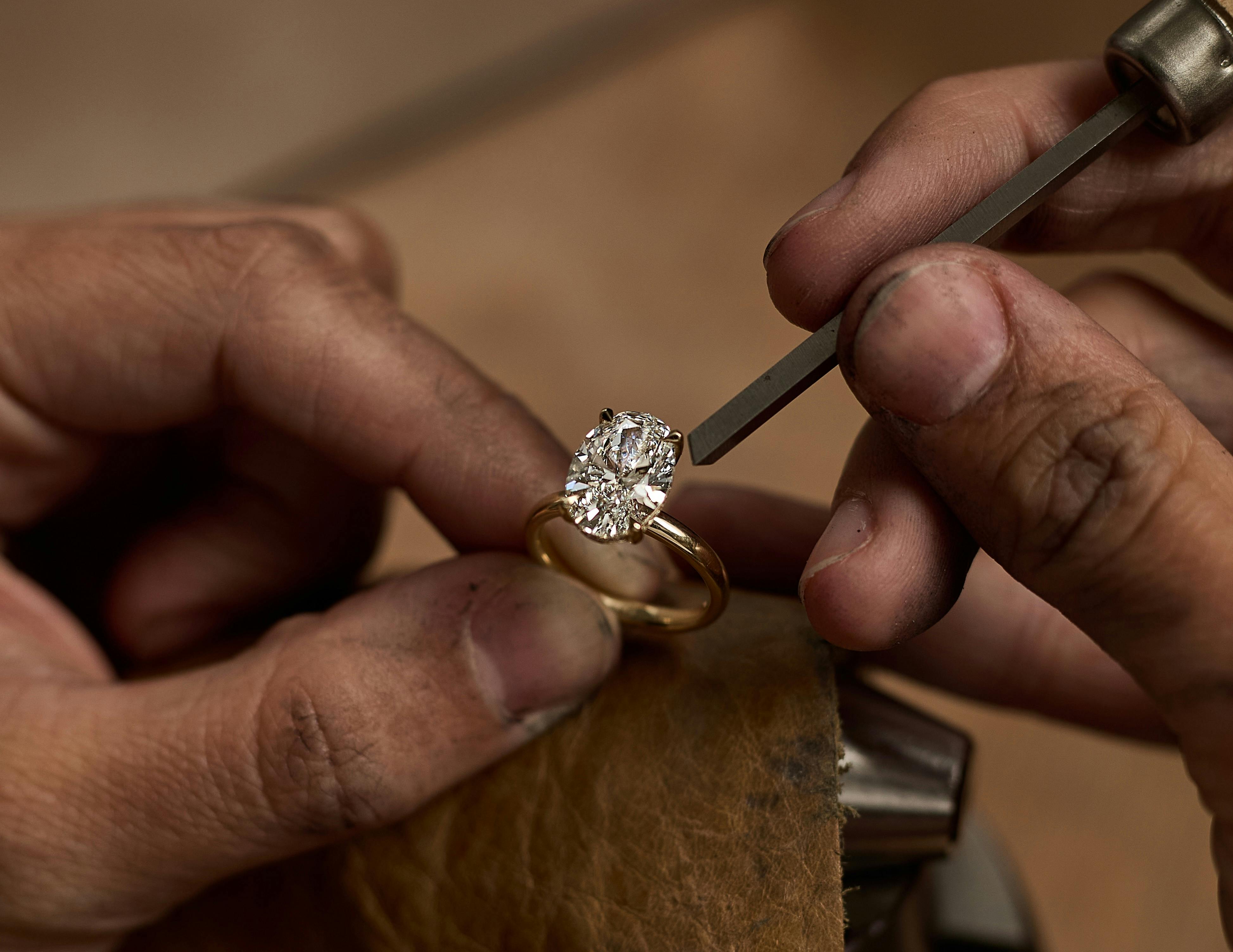 Oval diamond engagement ring in workshop.