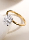 oval diamond solitaire engagement ring with plain yellow gold band