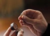 Anthony Bridgerton holds Violet Bridgerton's heirloom pearl engagement ring.