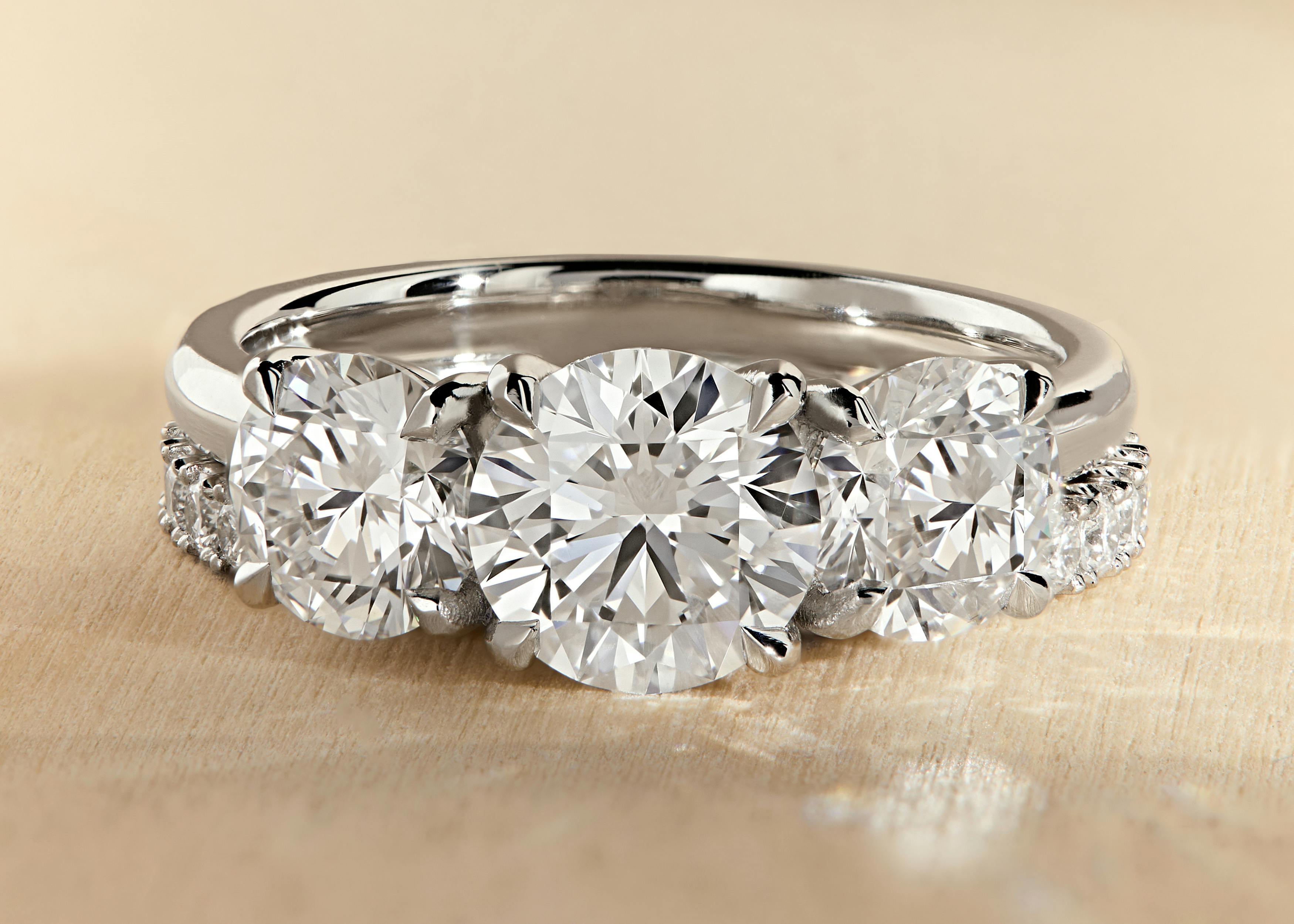 Round Cut Diamond O'Hara Trilogy Engagement Ring with Scallop Band.