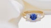 Sapphire and diamond trilogy engagement ring with yellow gold band.