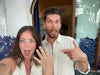 A couple's selfie showing off their bespoke emerald cut engagement ring after getting engaged, making shocked, happy faces