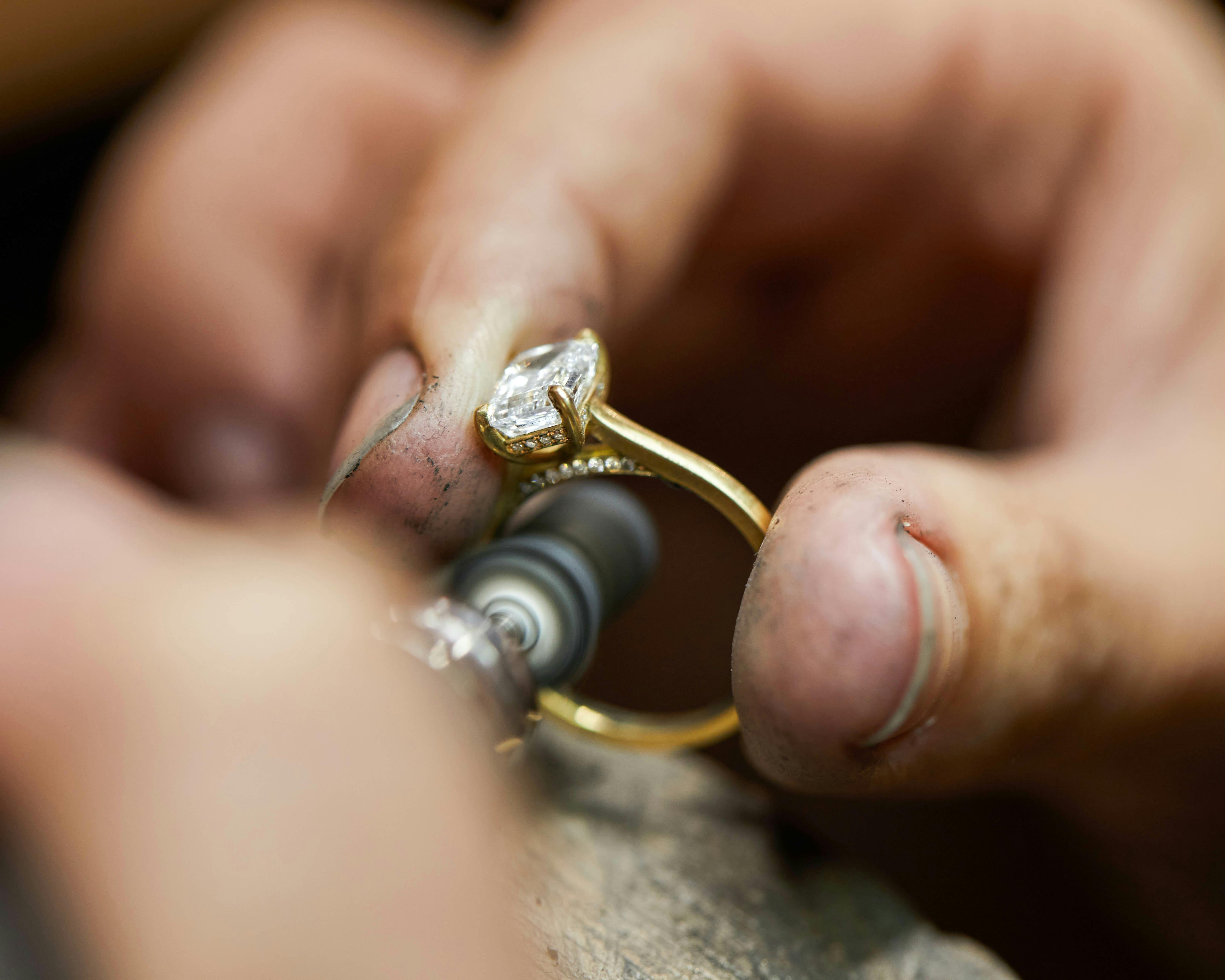 A goldsmith at work, crafting a beautiful engagement ring at Queensmith's Hatton Garden jewellery workshop