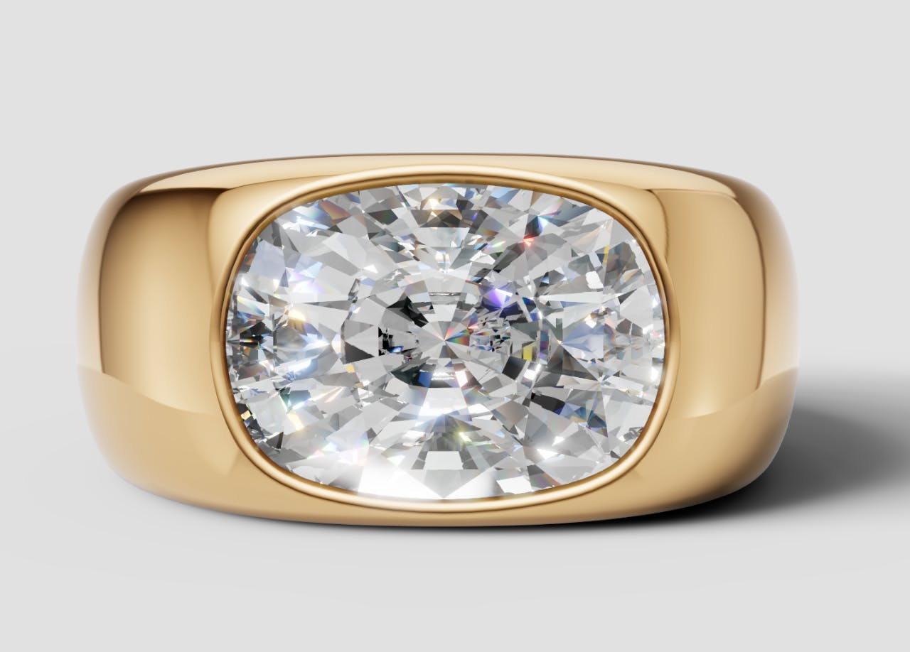 Queensmith's render of Miley Cyrus's engagement ring with an elongated cushion cut diamond, set east-to-west on a chunky yellow gold bezel band.