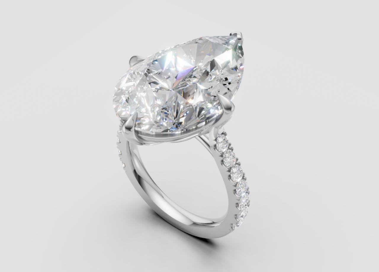 Angled view of large pear cut diamond ring render with diamond set band in platinum.