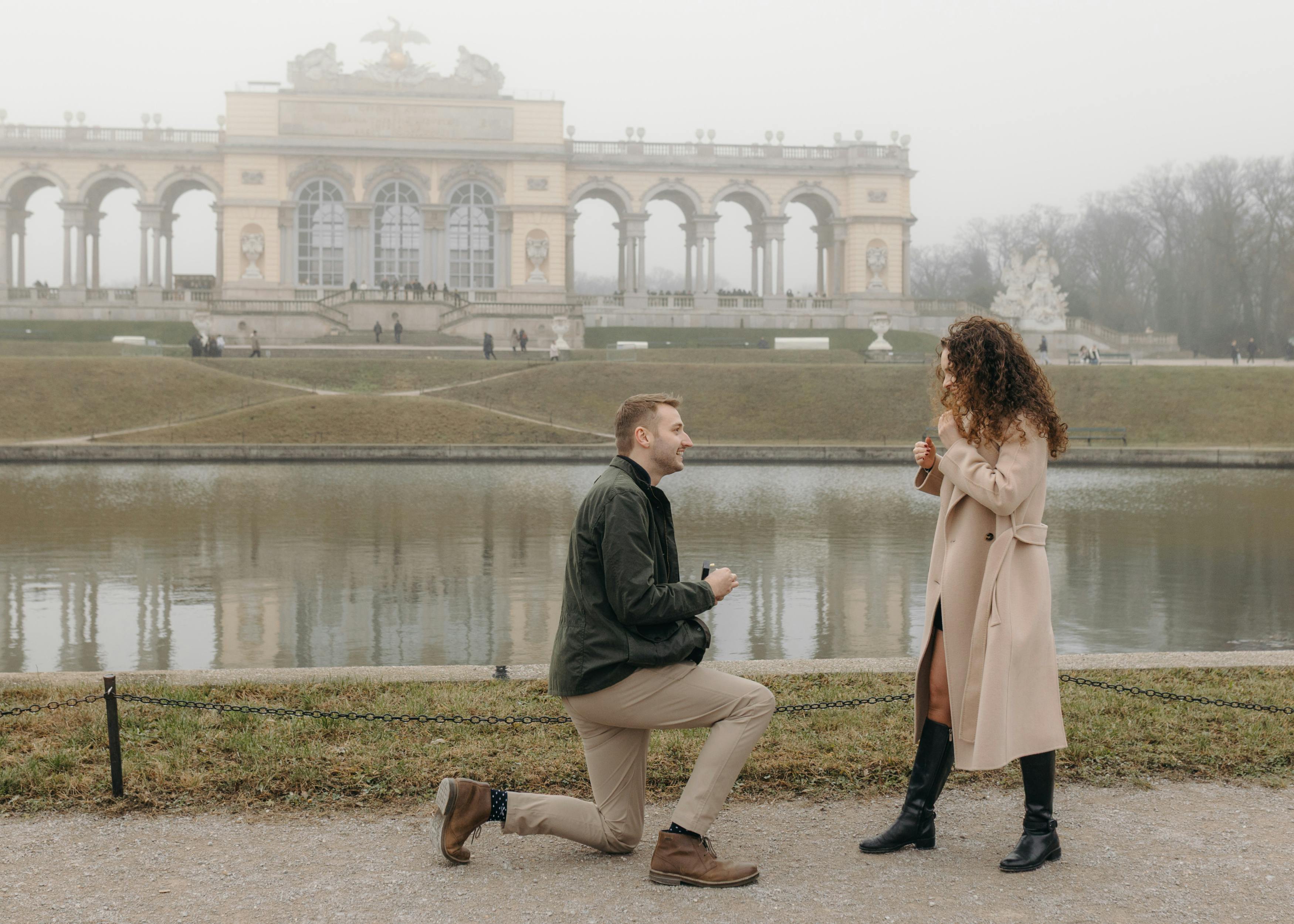 Samuel proposing to Ella on one knee at Schönbrunn Palace in Vienna, captured at the exact moment he asked her to marry him.