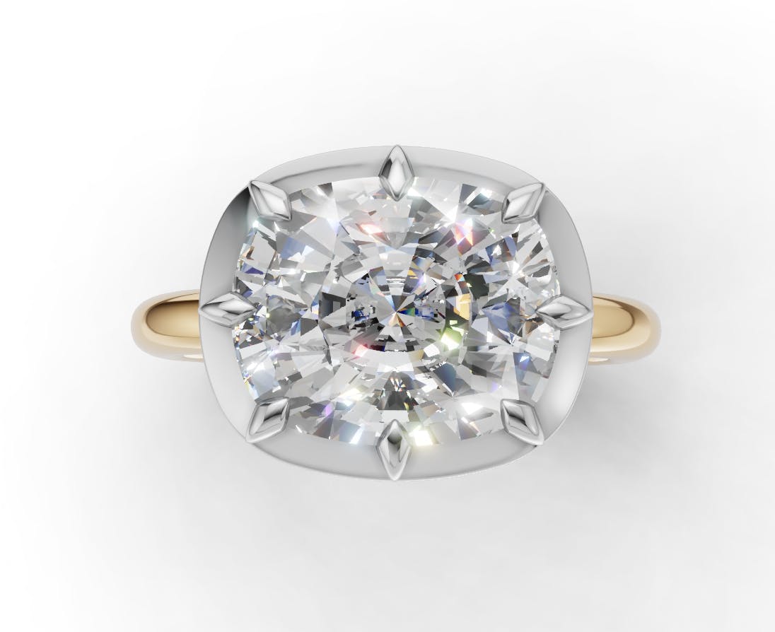 A render of Zendaya's engagement ring: an east-to-west cushion cut diamond with Georgian-style cut-down yellow gold and platinum/white gold setting.