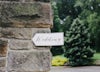 Arrow with the word 'wedding' on brick wall.
