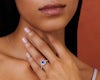 Woman wearing blue sapphire halo engagement ring.