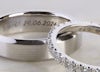 Wedding rings with initial engravings – men's plain band and women's scallop band in platinum.
