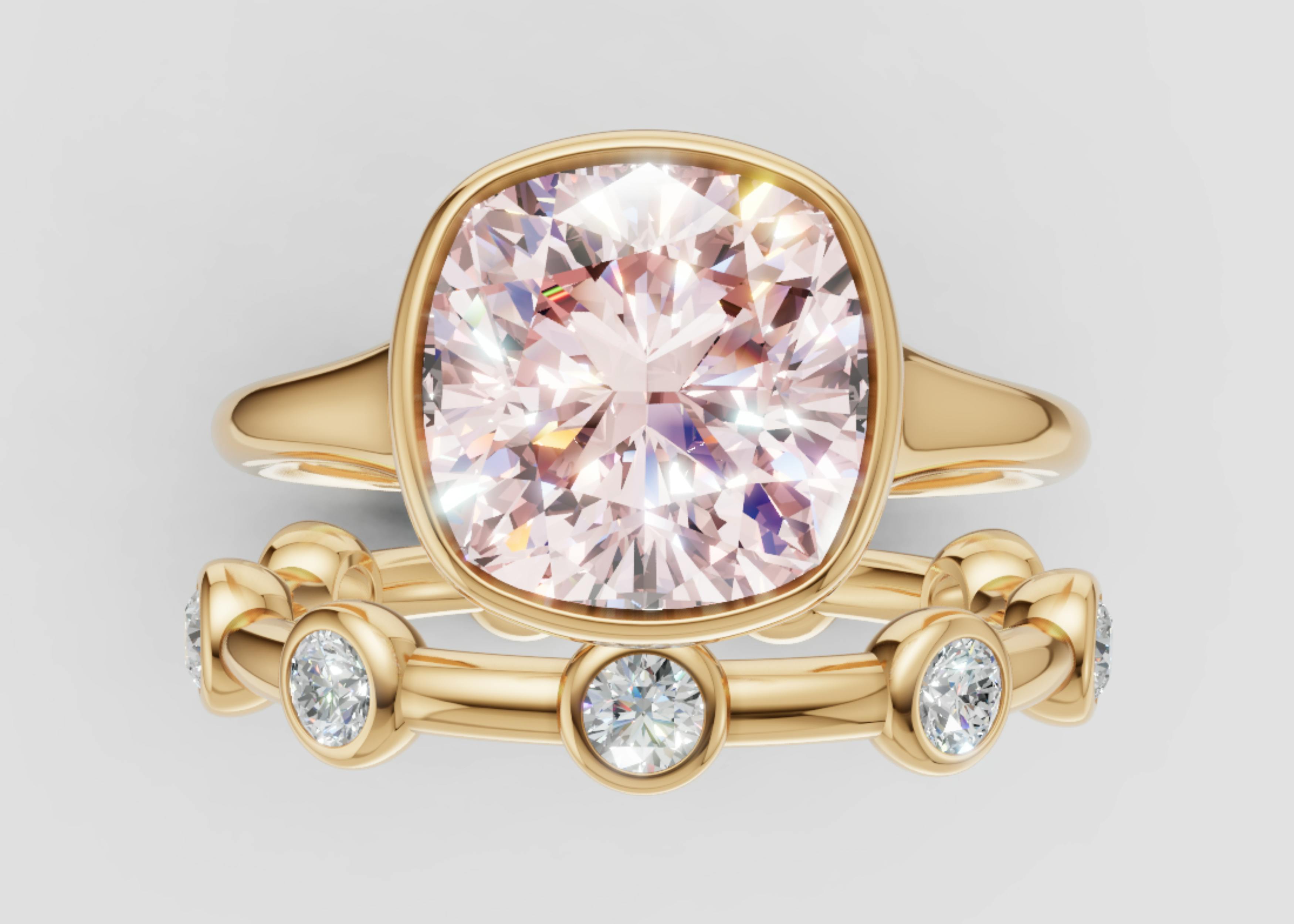 Queensmith render of Lily Collins’ first engagement ring with a cushion cut pink diamond in an 18k yellow gold bezel setting, paired with a dainty diamond bezel-set wedding band.