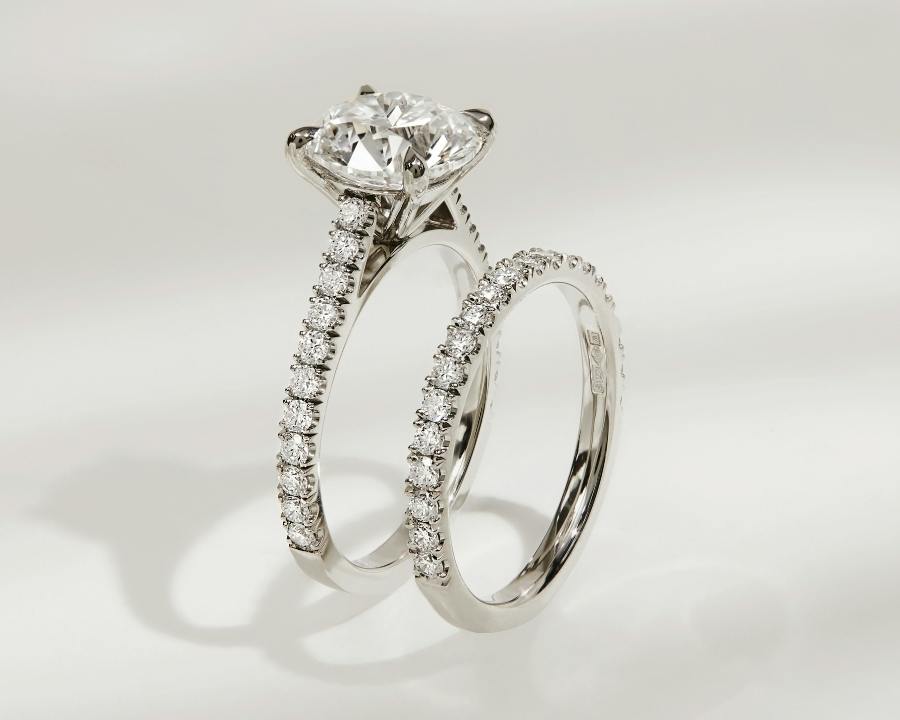 An image of a matching diamond engagement ring and wedding band bridal set in platinum.