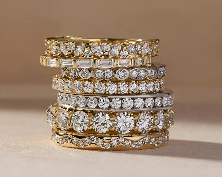 A close-up image of a variety of stacked mix metal rings.