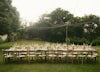Outdoor wedding long dinner table with fairy lights.