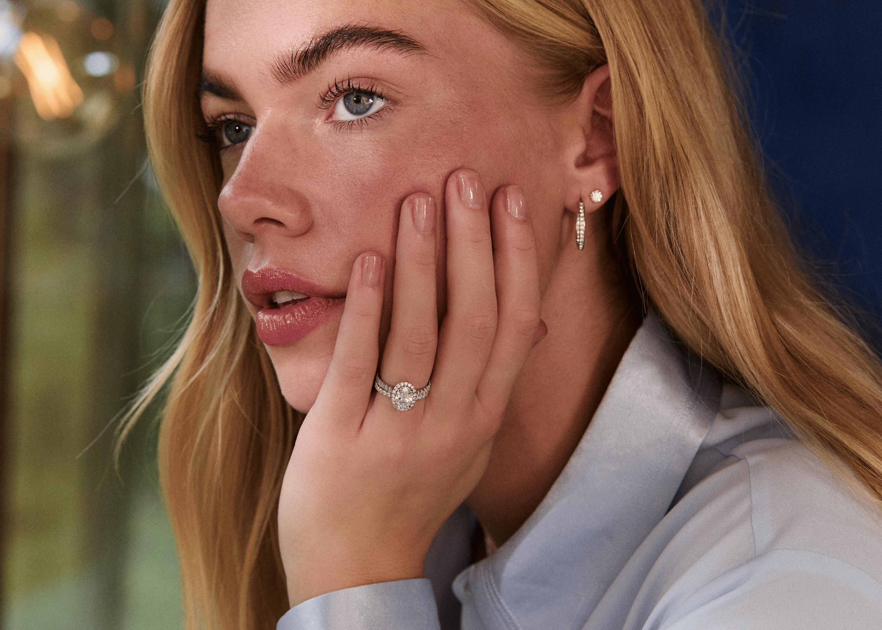 Platinum ring stack diamond band oval halo engagement ring and diamond set wedding ring.